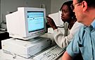 Faculty and student working at a computer