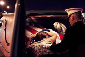 Katherine Cathey, 23, embraces the coffin of her husband James C. Cathey, 24, a Marine Second Lieutenant