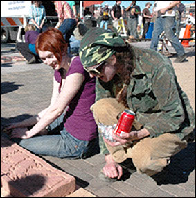 Rian Kerrane, right, helps a student balance her mold.